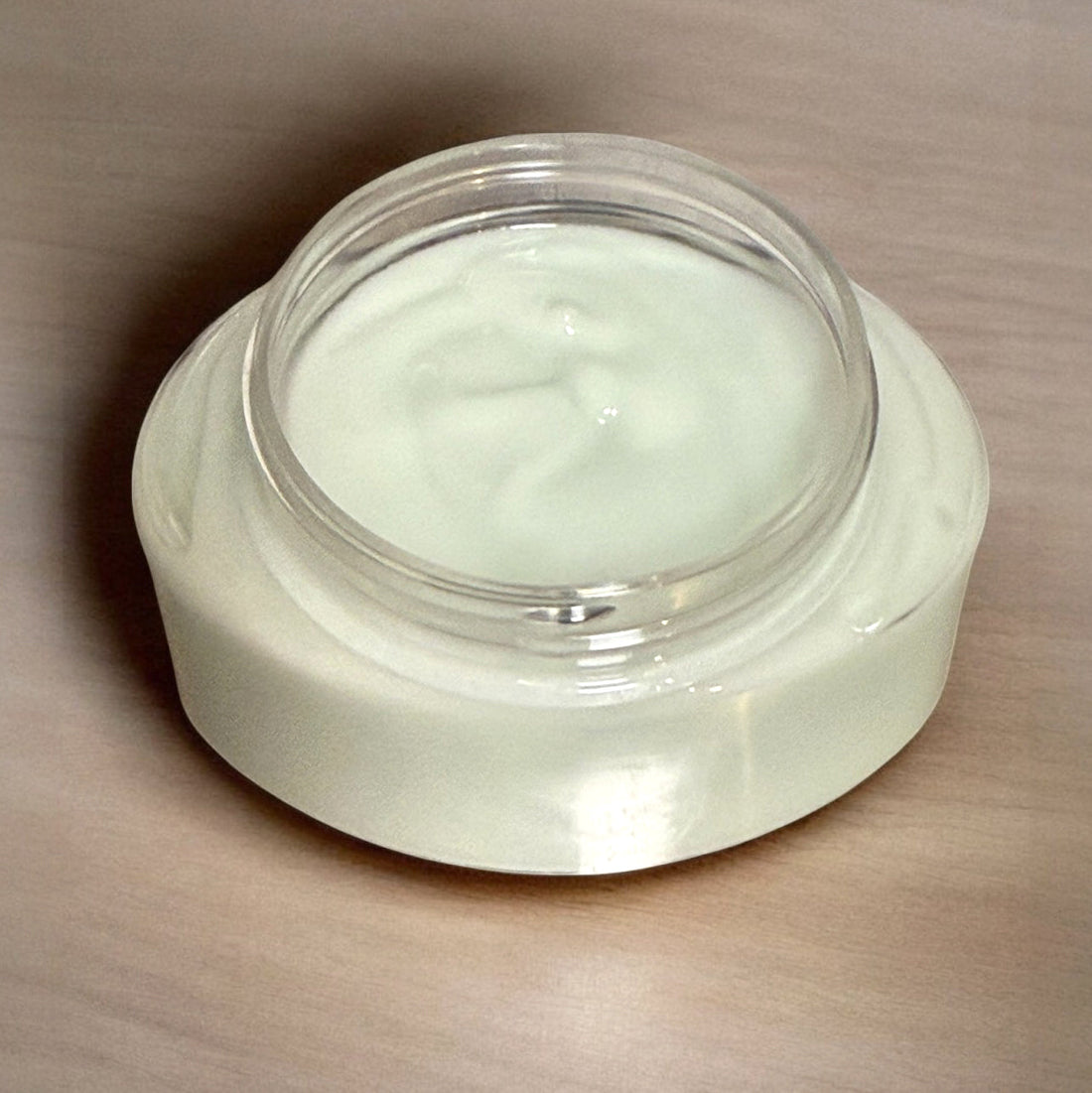 Jar of GOOW Magnesium Cream Lotion on a nightstand at bedtime