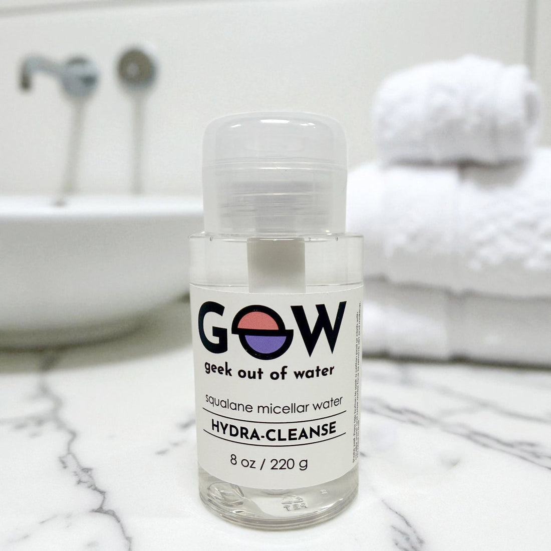 GOOW Hydra-Cleanse Squalane Micellar Water bottle with a cotton pad on a bathroom counter