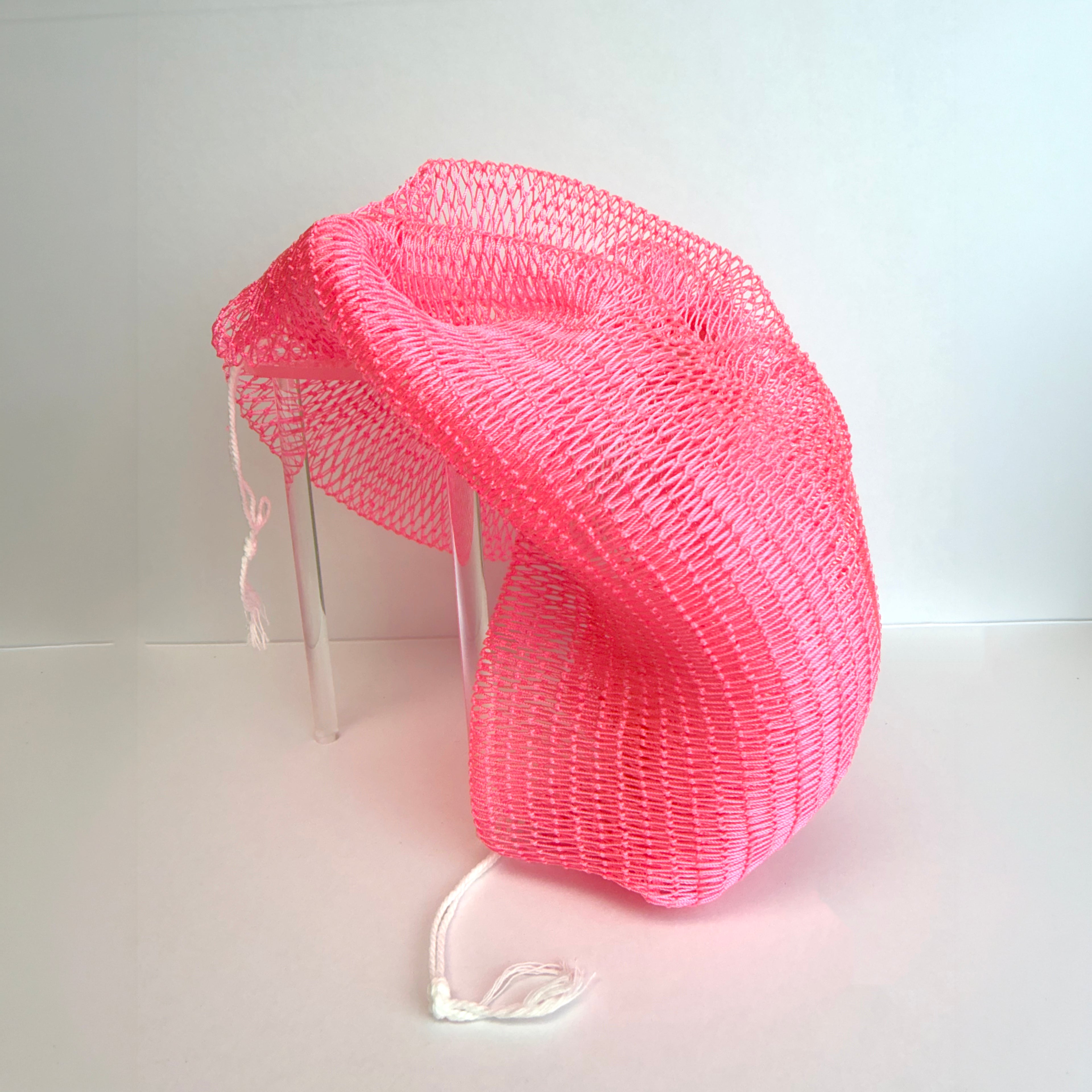Pink net sponge draped over a stand 