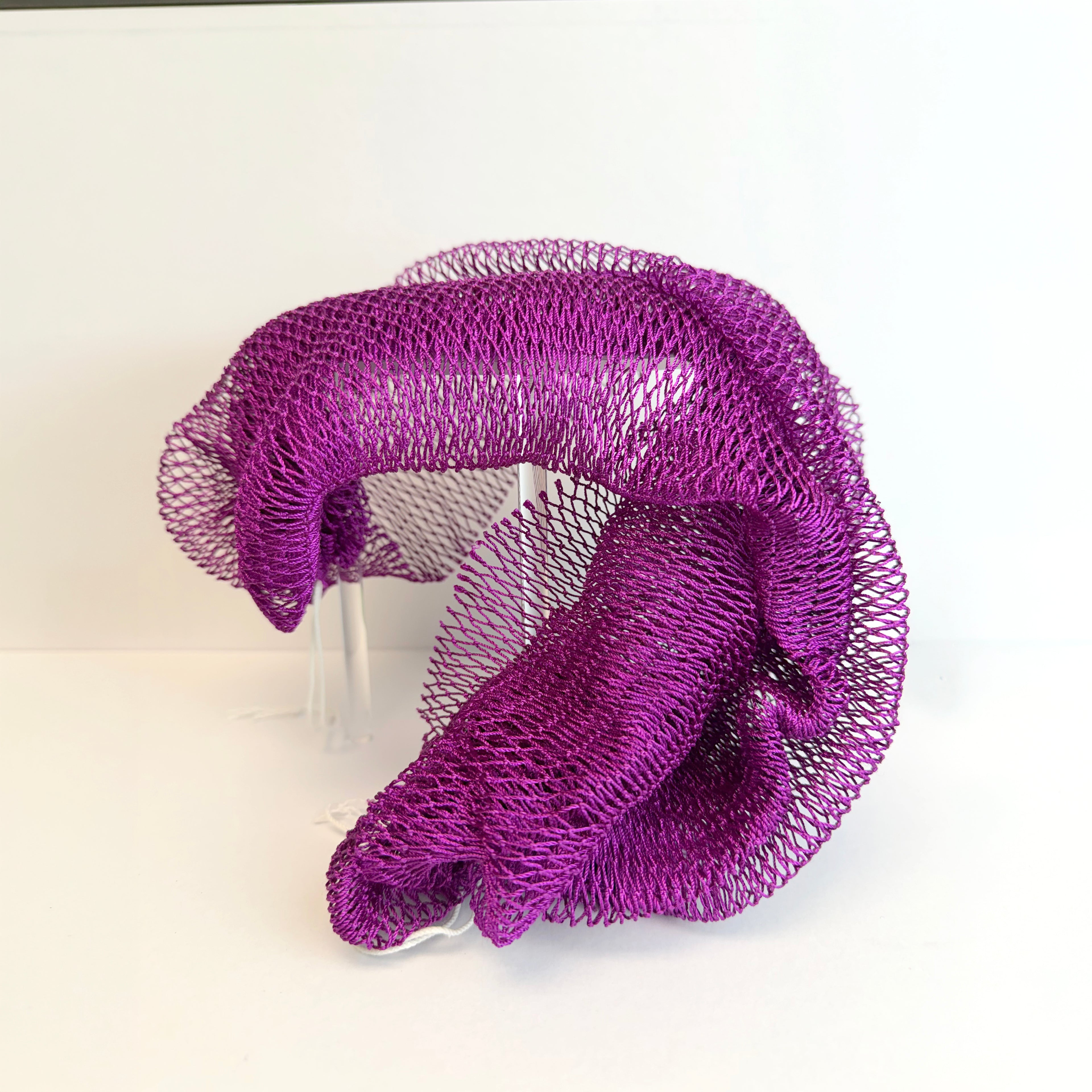 Purple net sponge draped over a stand 